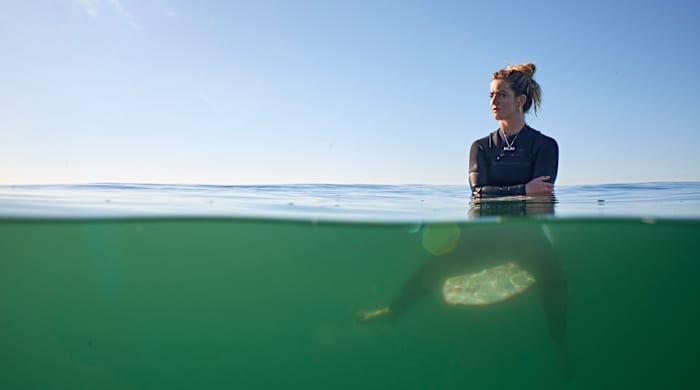 Caroline Marks on her surfboard.